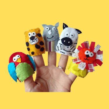 a person's hand holding a finger puppet animal finger puppets