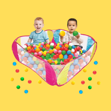 two babies playing in a ball pit with balls