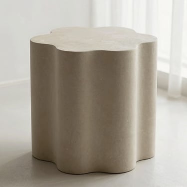 Matte sand-colored 3D printed organic sculpture styled on a minimalist concrete side table, soft side lighting