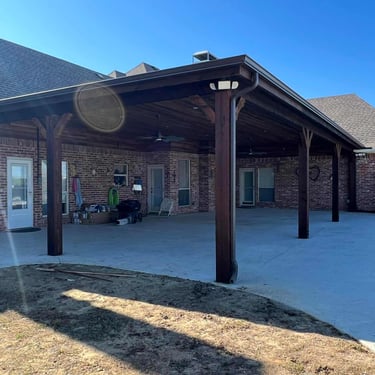Large covered patio with dark wood posts.