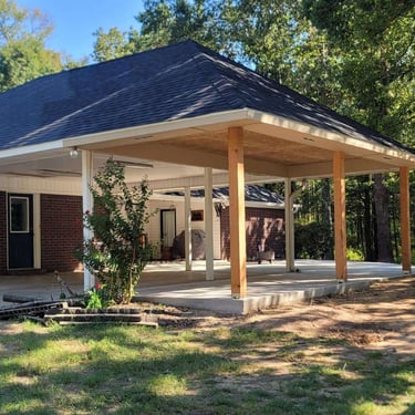 Covered outdoor patio area with hip roof.