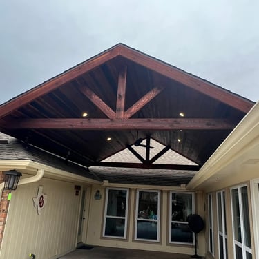 Covered patio with vaulted wood ceiling.