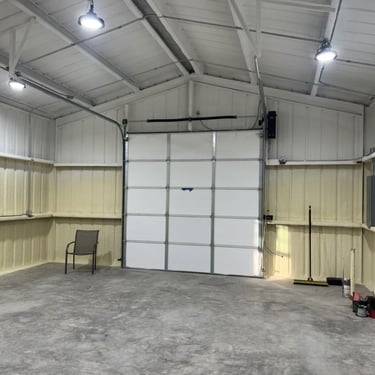 Clean interior of metal garage with spray foam insulation.
