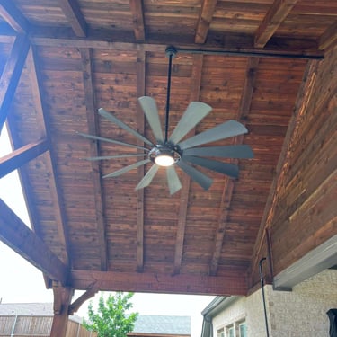 Covered patio ceiling with large modern ceiling fan.