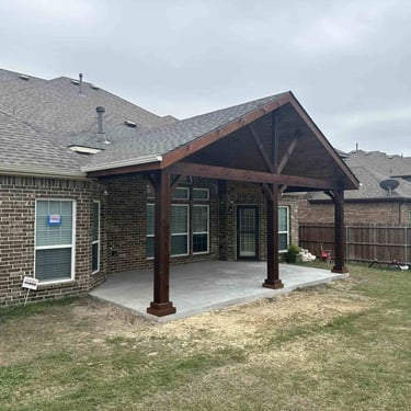 Gable-style covered patio with dark wood posts.