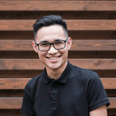 a man in a black shirt and glasses
