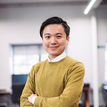 a man in a yellow sweater and a white shirt