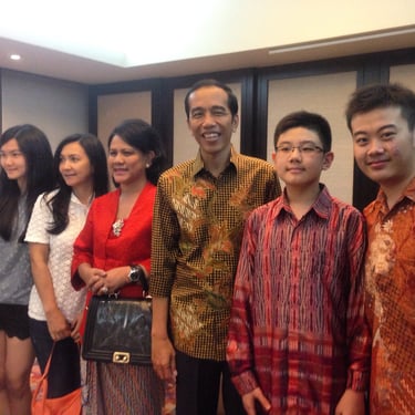 a group of people standing in front of a room
