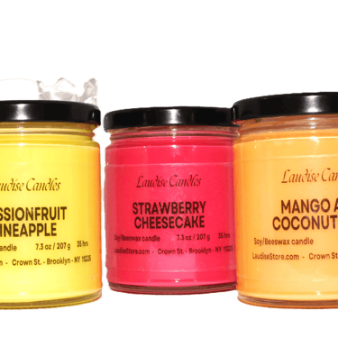Three jars of soy candles on a table