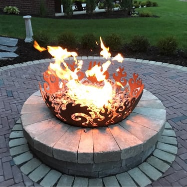 Leppek Landscapes custom fire pit and fire bowl on patio. 