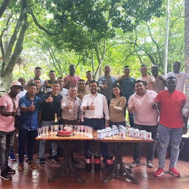 a group of people standing around a table with drinks