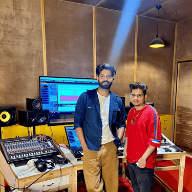 a man and a woman standing in a recording studio