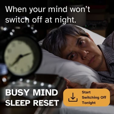 An awake person suffering from insomnia looks at a bedside alarm clock during a busy mind sleep reset.