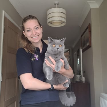 Fleur holding her British Shorthair cat.