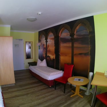 a bedroom with a bed and a desk