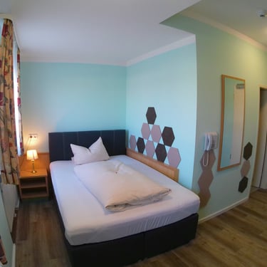 a bedroom with a bed and a bed in the corner