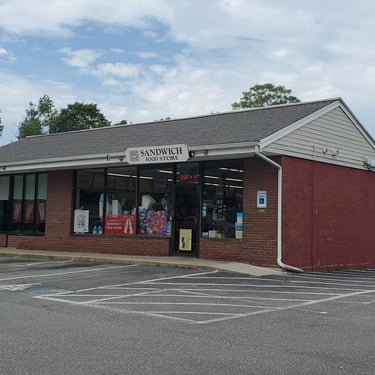 exterior of the convenience store building and part of the parking area