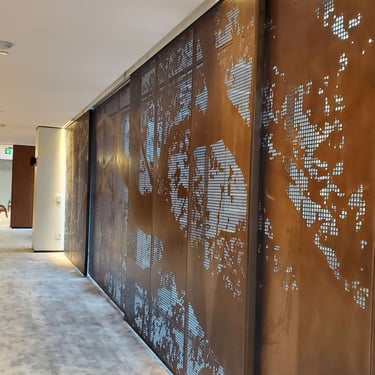 Bronze screen in a boardroom with beautiful tree and mesh laser cut design, by Pengelly Iron Works 