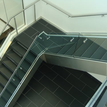 Black tiled office stairs with white accents, metalwork done by Pengelly Iron Works 