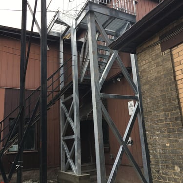 Alternate view of fire escape style stairs, showing tall structural beam work, fabricated by Pengelly Iron Works 