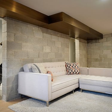 Home interior brass air vent above a couch, made by Pengelly Iron Works