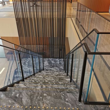 Scotiabank North marble feature stairs, with cascading metal feature, done by Pengelly Iron Works
