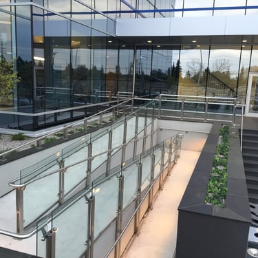 Accessibility ramp outside office building with modern design and lighting, by Pengelly Iron Works