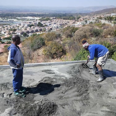 Flat concrete roof screed layer application, North West Province