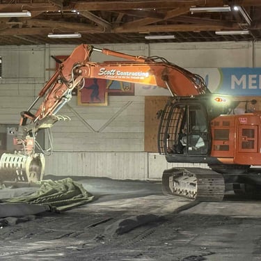 Excavator Inside an Arena lifting up turf