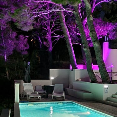 The photo shows the illuminated pool and part of the courtyard with ambient light.