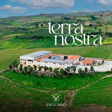 a farm with a large field and a large building with a large building in the