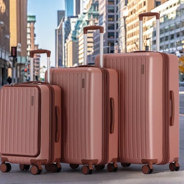 three suitcases with luggage bags on the sidewalk