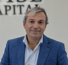 a man in a blue suit and white shirt