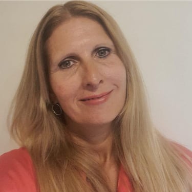 a woman with blonde hair and a pink shirt