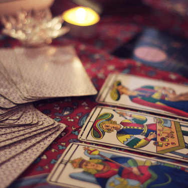 a table with cards and a candlelight