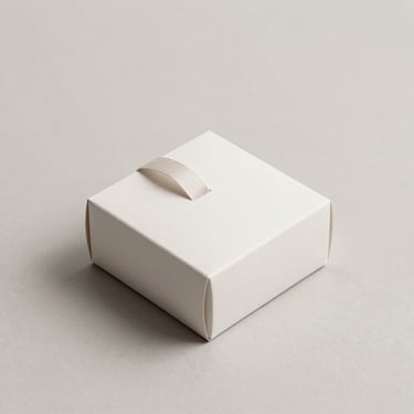 Minimalist flat-lay of a custom gift box with a ribbon attachment, clean edges, soft shadows, neutral minimalist backdrop, 85mm