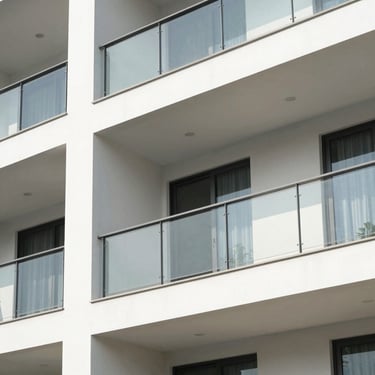 Crisp architectural photography of a modern luxury apartment balcony in Delhi NCR, bright natural daylight, clean lines, 35mm