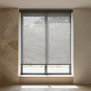 Minimalist interior window with premium grey roller blinds, soft filtered sunlight illuminating a modern room