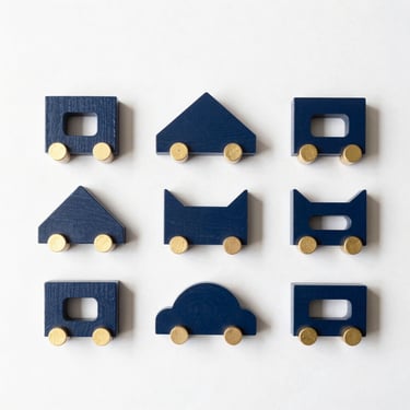 Minimalist wooden toys arranged in a structured flat-lay under natural daylight, clean composition.