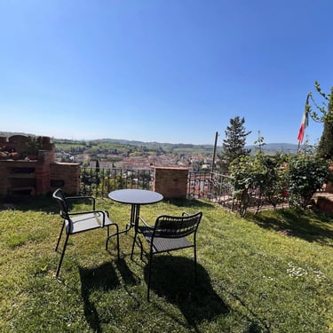 Scenic garden terrace in Certaldo Alto, Tuscany, featuring a cozy seating area and panoramic valley views