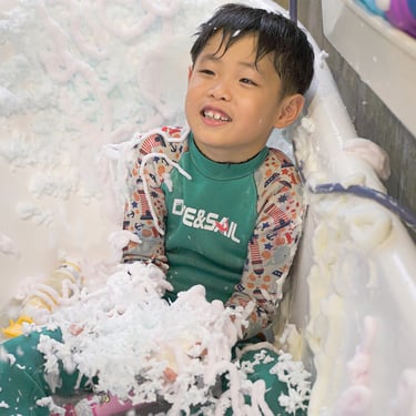 kid happy bath time with sploo foam soap in bathtub 