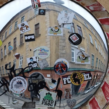 A traffic mirror full of stickers at the corner of Klauzál tér and Dob utca, Budapest, Hungary