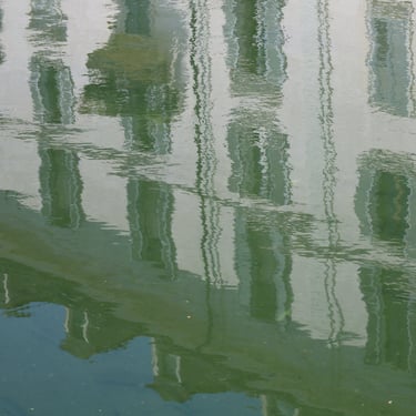 Wobbly reflection of building at one of the Navigli canals in Milan, Italy.