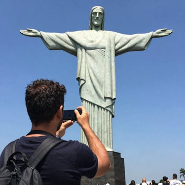 A smiling man with a fresh haircut sitting in a barber chair.