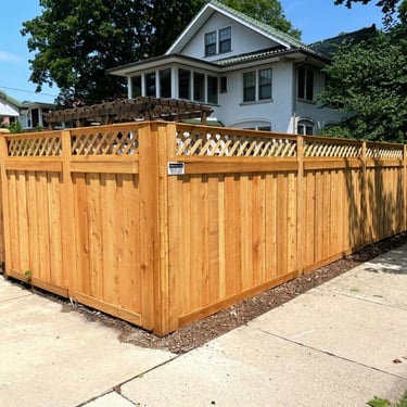 Custom wood privacy fence with lattice top installed in a Long Island residential neighborhood.