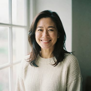 Candid portrait of a smiling woman in her 40s in a cozy knitted sweater, soft natural window light, editorial style
