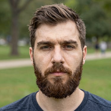 A happy young man holding a collection of Pokémon cards with a bright smile.