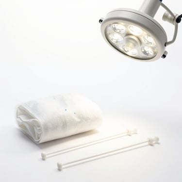 Advanced wound care dressings and sterile surgical sutures, clinical high-key lighting, white background, sharp focus, square aspect.