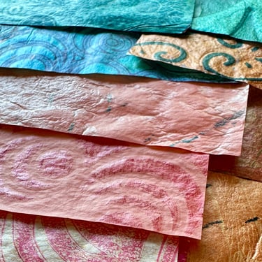 Warm copper and teal collage papers with layered paint texture