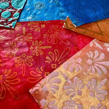 Red and gold patterned collage papers with floral stencil details